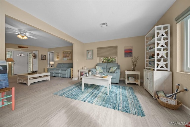 living room featuring ceiling fan and light hardwood / wood-style floors