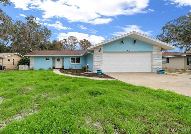 ranch-style house with a garage and a front lawn