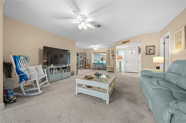 living room with ceiling fan and light colored carpet