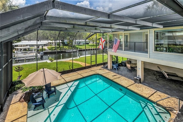 view of swimming pool with a water view, a lawn, a patio area, and glass enclosure