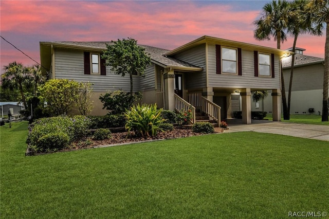 view of front facade with a lawn and a carport