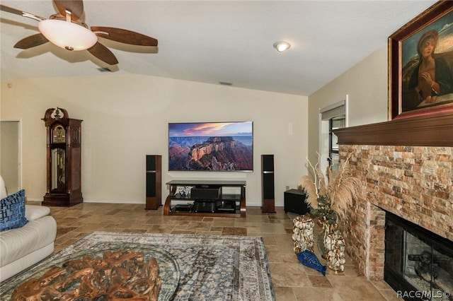 living room featuring ceiling fan, lofted ceiling, and a fireplace