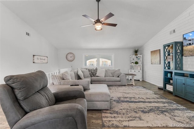 living room with dark hardwood / wood-style floors, ceiling fan, and high vaulted ceiling