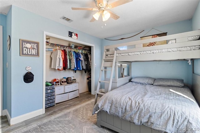 bedroom with ceiling fan, a closet, and hardwood / wood-style floors