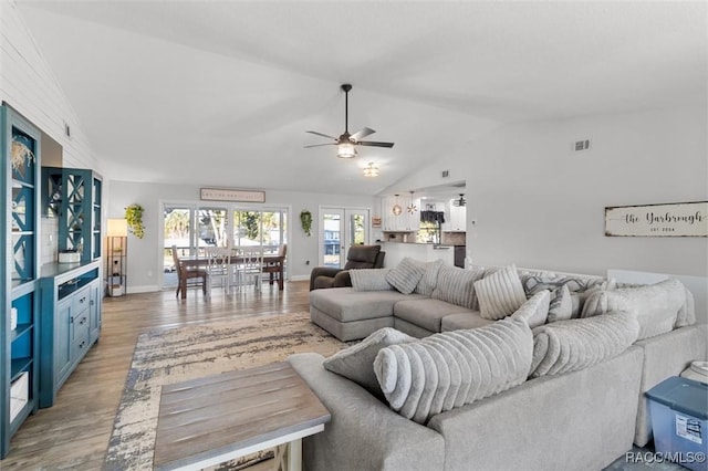 living room featuring ceiling fan, french doors, wood-type flooring, and vaulted ceiling