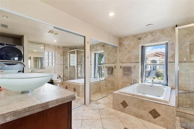 bathroom with vanity, tile walls, and independent shower and bath