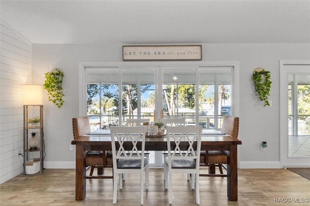 dining area featuring lofted ceiling and hardwood / wood-style flooring