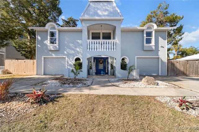 view of front property featuring a garage and a balcony