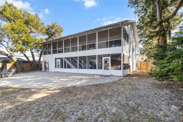 back of property featuring a sunroom and a patio area