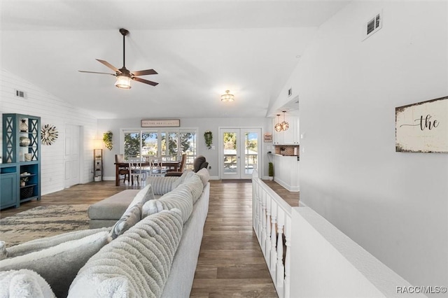 living room featuring french doors, dark hardwood / wood-style flooring, vaulted ceiling, and ceiling fan