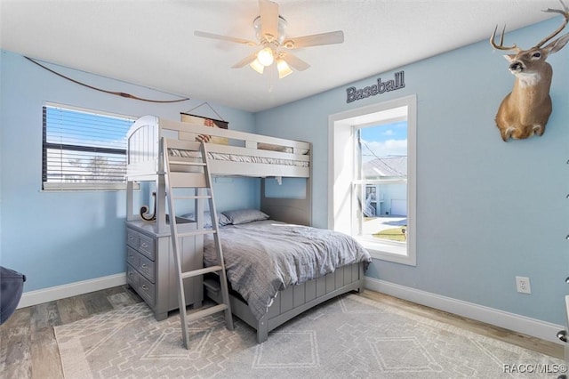 bedroom with wood-type flooring and ceiling fan