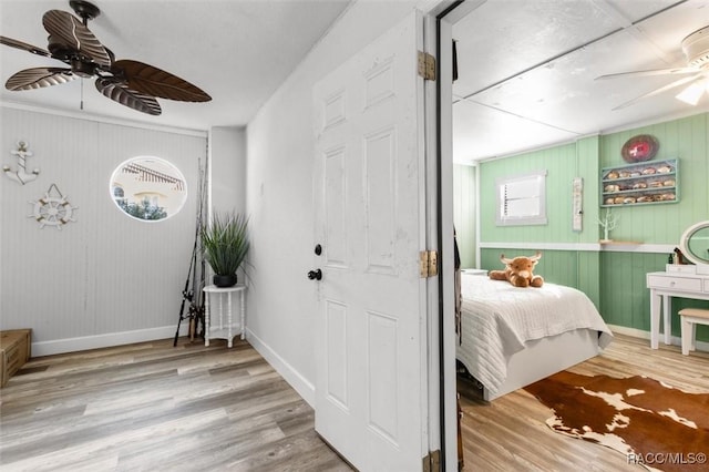 bedroom with wood-type flooring and ceiling fan