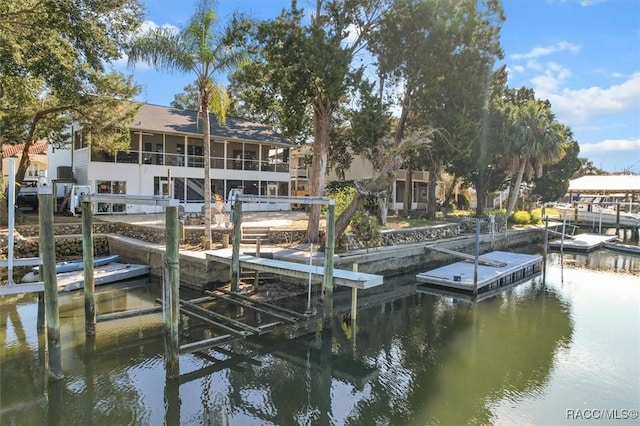 view of dock featuring a water view and a balcony