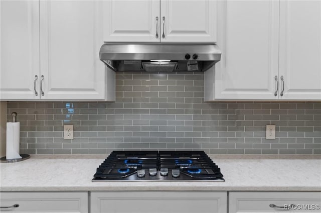 kitchen with white cabinetry, backsplash, exhaust hood, and stainless steel gas stovetop