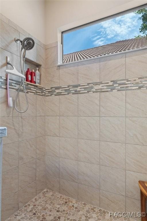 bathroom with tiled shower