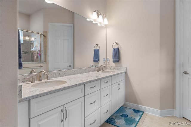 bathroom featuring vanity, a shower with door, and tile patterned flooring