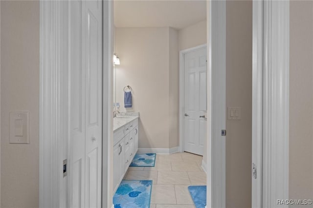 bathroom featuring tile patterned flooring and vanity