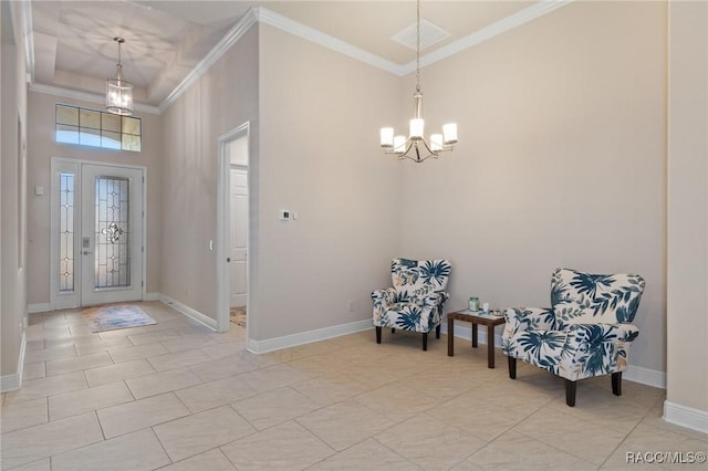 tiled foyer featuring crown molding and a notable chandelier