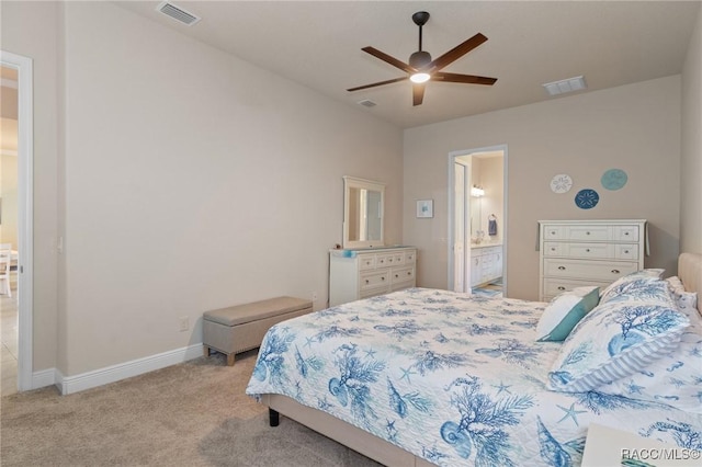 carpeted bedroom with ensuite bath and ceiling fan