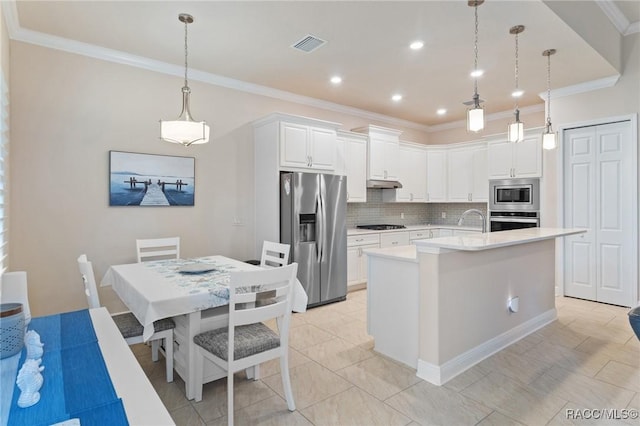 kitchen featuring stainless steel appliances, white cabinetry, hanging light fixtures, and an island with sink