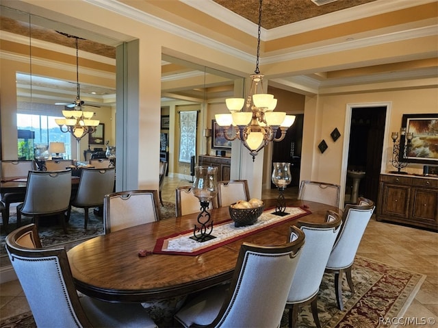 dining space featuring a tray ceiling, crown molding, tile patterned flooring, and ceiling fan with notable chandelier