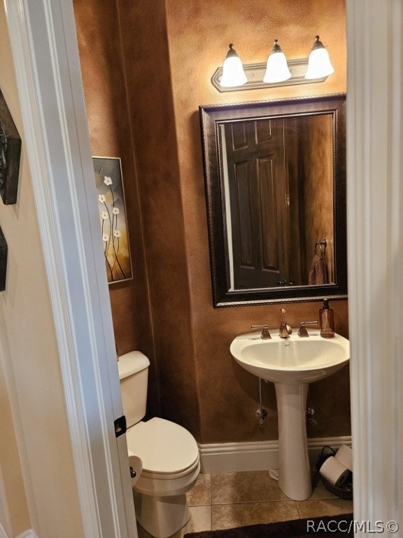 bathroom with tile patterned flooring and toilet