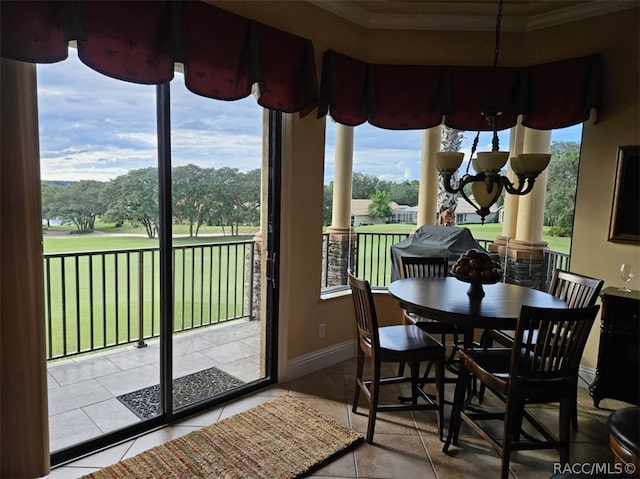 sunroom / solarium with plenty of natural light and a chandelier