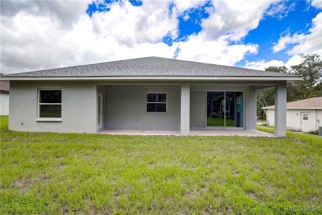 back of property featuring a yard and a patio