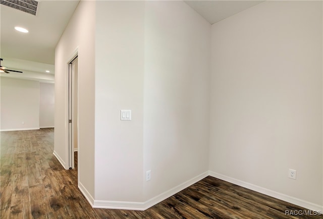 spare room featuring dark hardwood / wood-style floors and ceiling fan