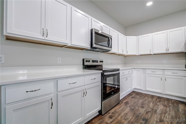 kitchen featuring white cabinets, stainless steel appliances, and dark hardwood / wood-style floors