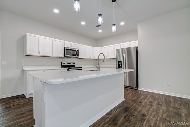 kitchen featuring white cabinets, dark hardwood / wood-style flooring, stainless steel appliances, and a center island with sink