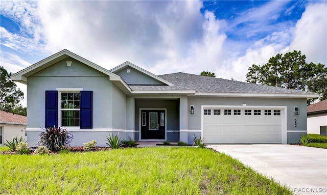 view of front of home with a front lawn and a garage