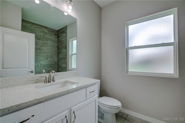 bathroom featuring tile patterned flooring, vanity, and toilet