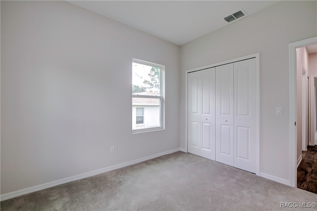 unfurnished bedroom featuring a closet and carpet