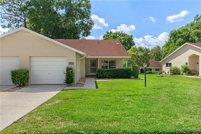 3621 N Lucille Dr, Beverly Hills, FL 34465 - view of front facade with a garage, a front lawn, and concrete driveway