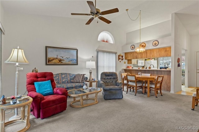3621 N Lucille Dr, Beverly Hills, FL 34465 - carpeted living room featuring high vaulted ceiling, ceiling fan, and a chandelier