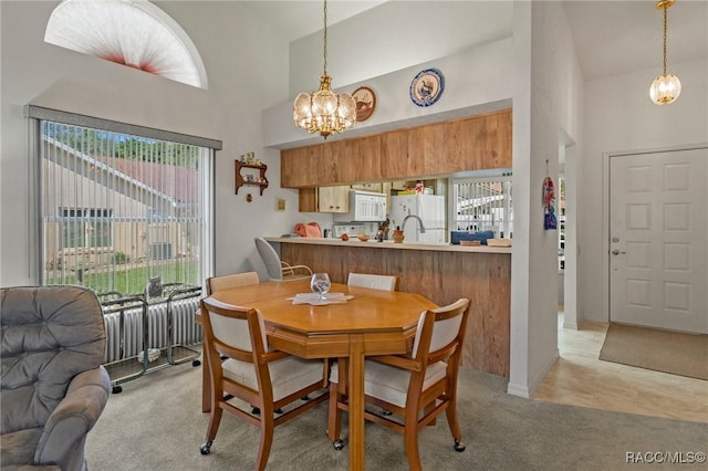 3621 N Lucille Dr, Beverly Hills, FL 34465 - dining space featuring high vaulted ceiling, a chandelier, and light colored carpet