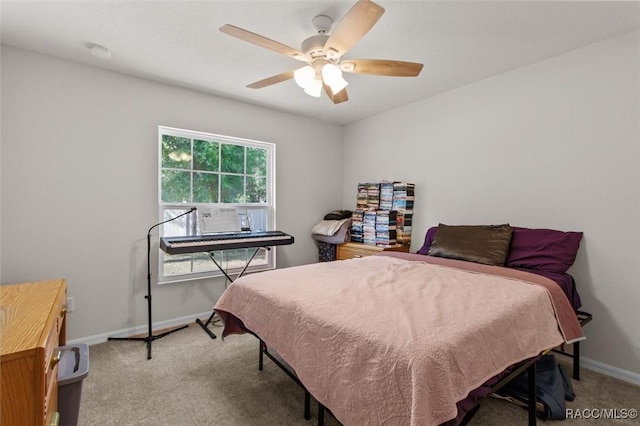 bedroom featuring light colored carpet, ceiling fan, and baseboards