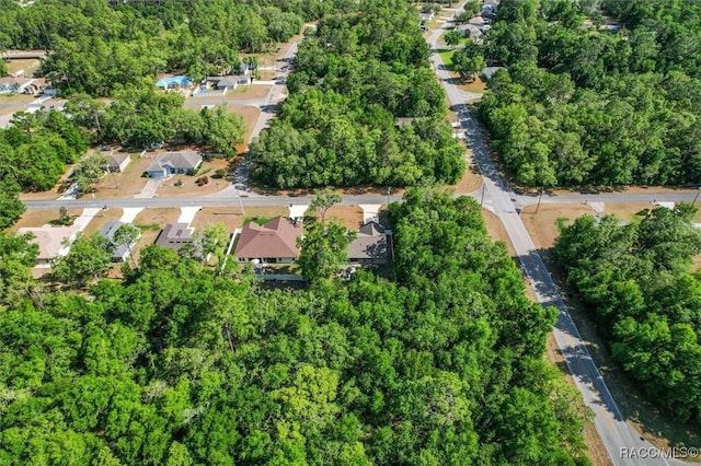 birds eye view of property with a forest view