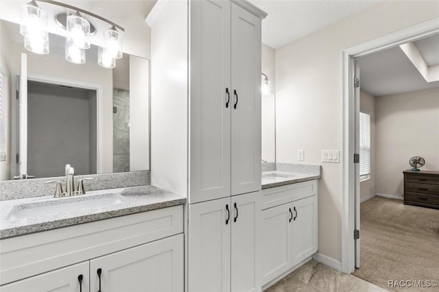 bathroom with vanity and baseboards