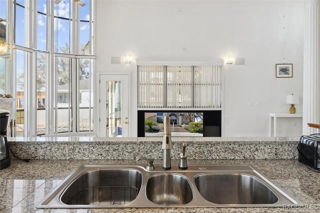 kitchen with a sink and a towering ceiling