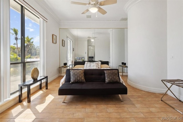 bedroom featuring baseboards, ornamental molding, light wood-style floors, a closet, and a ceiling fan