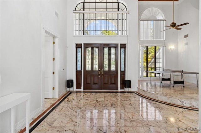 foyer entrance with visible vents, baseboards, ceiling fan, french doors, and marble finish floor