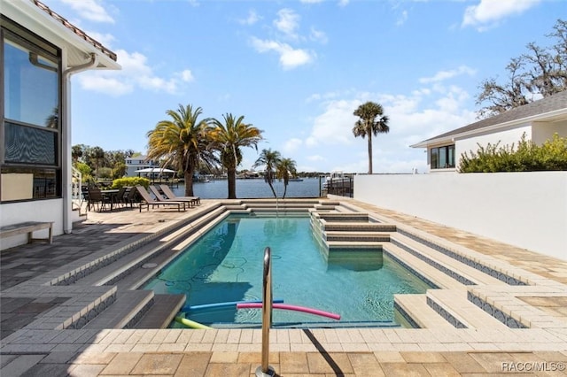 pool featuring a patio and a water view