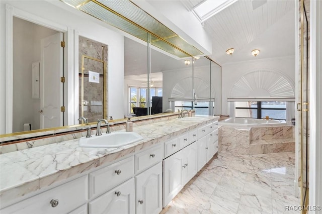 bathroom featuring double vanity, marble finish floor, a stall shower, and a sink