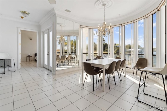 interior space with light tile patterned floors, visible vents, a notable chandelier, and ornamental molding