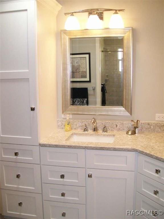 bathroom featuring an enclosed shower and vanity