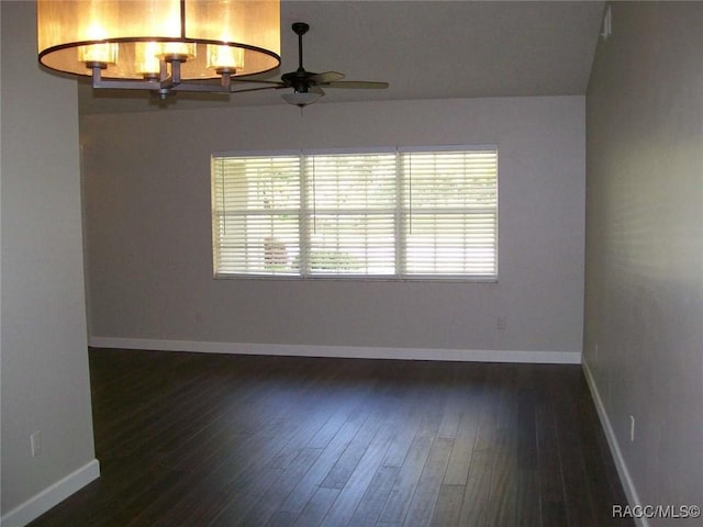 empty room featuring dark wood-type flooring and ceiling fan