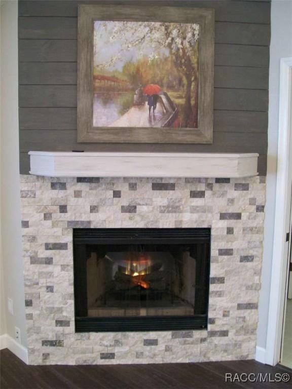 details with hardwood / wood-style flooring and a fireplace