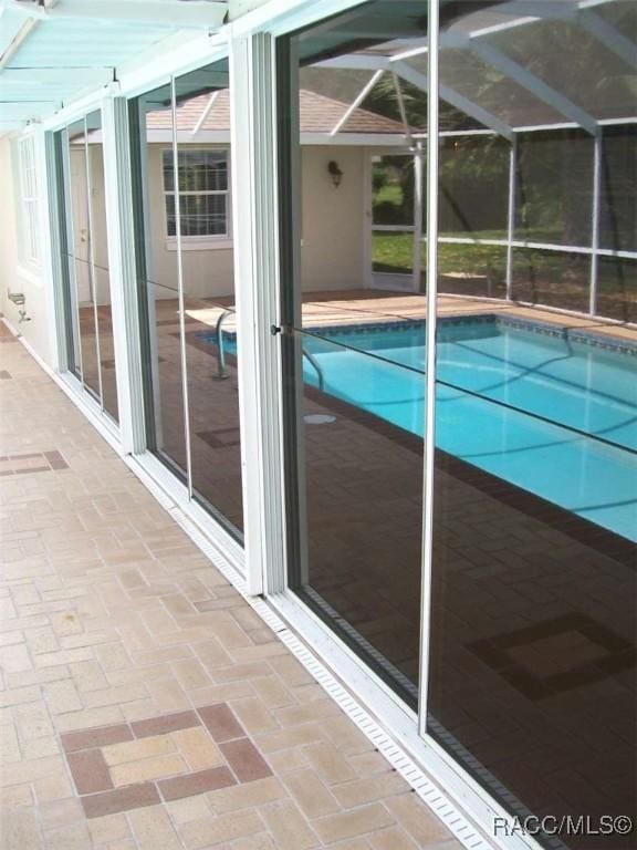 view of pool with a lanai